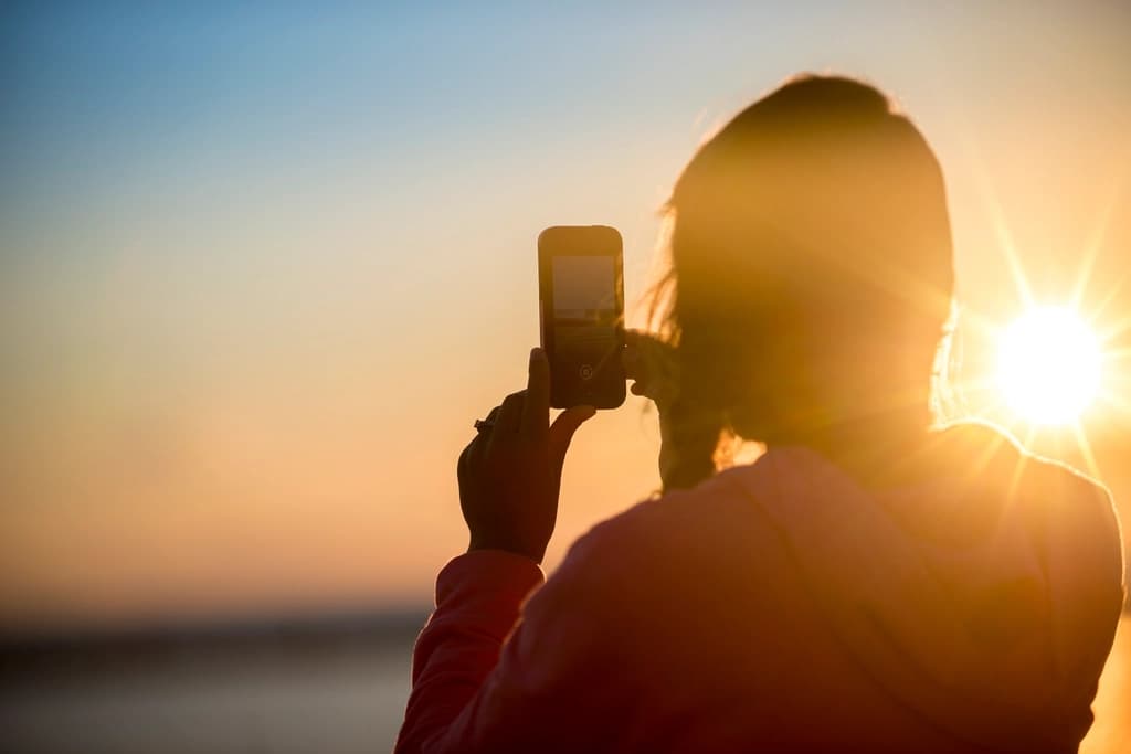 A creator filming at sunset